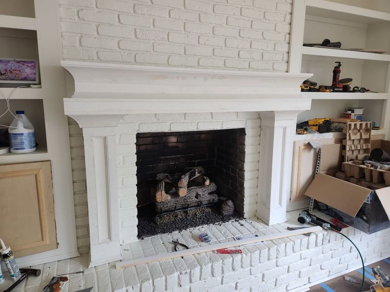 Painted brick fireplace with built-ins